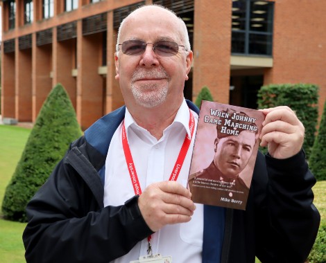 John Berry holds up the book When Johnny Came Marching Home.